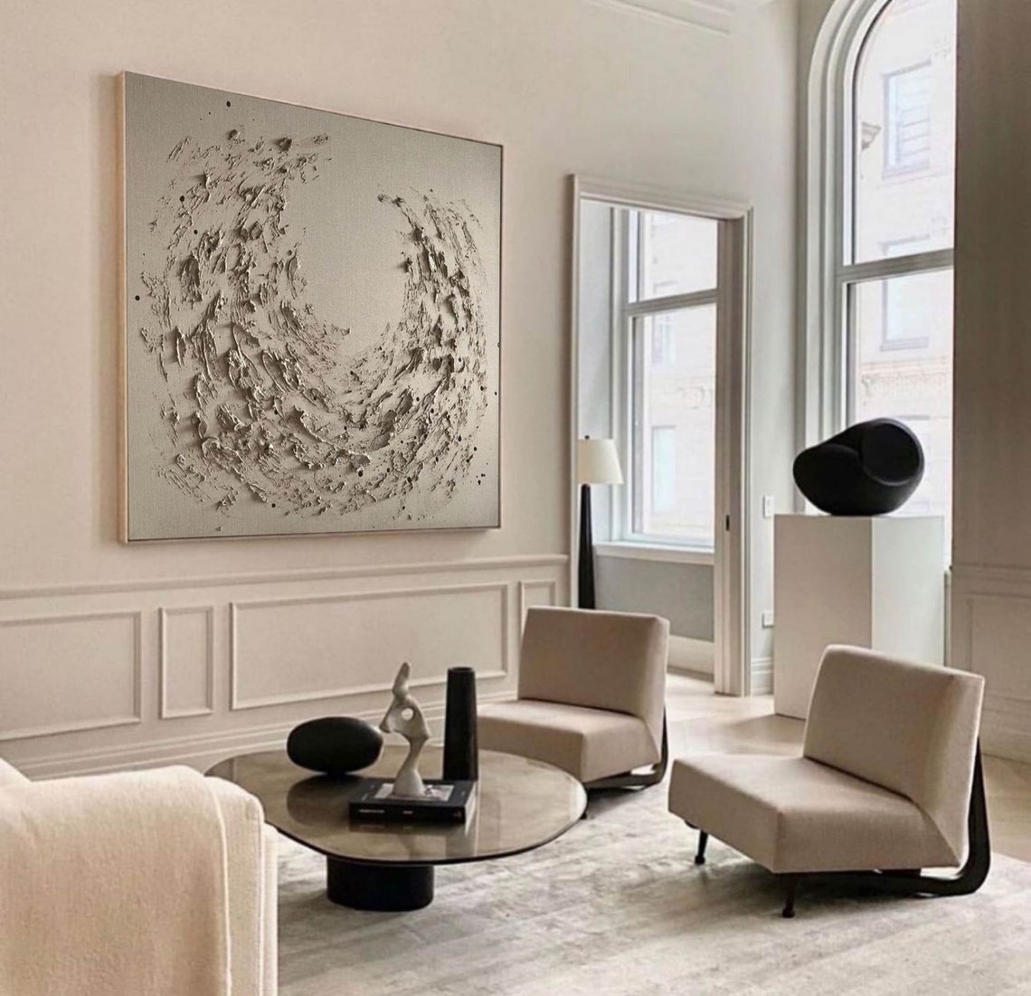 Textured abstract wall decor featuring dynamic swirling design in neutral tones.