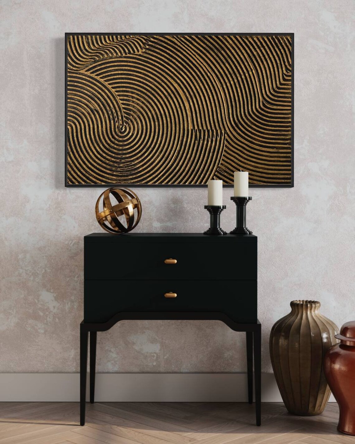 Metallic abstract canvas painting with gold and black concentric circular patterns.