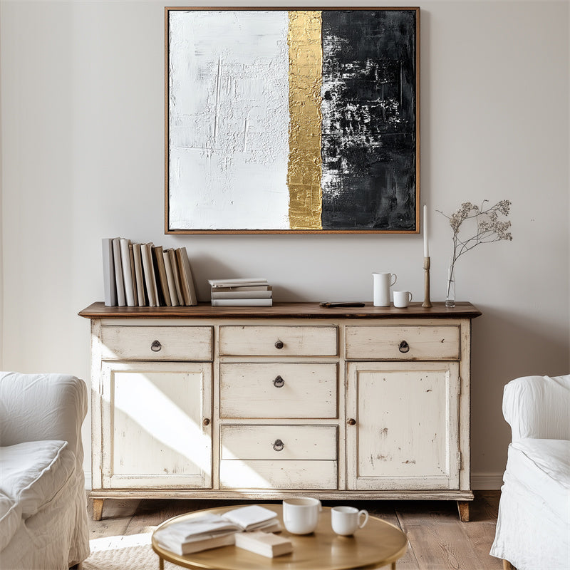 Abstract textured wall art with gold stripe, featuring black and white sections.