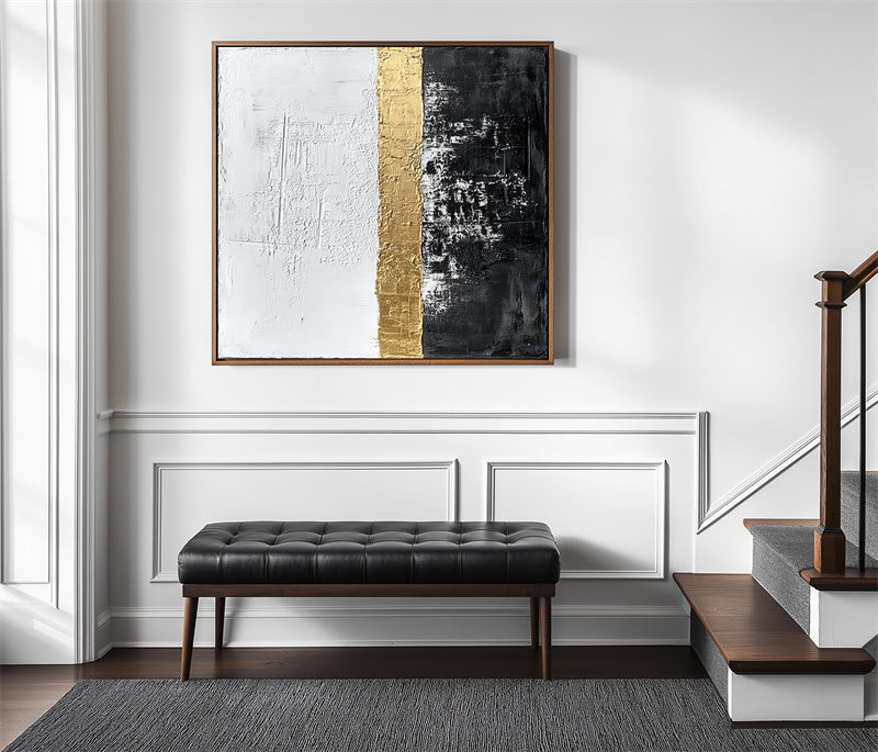 Abstract textured wall art with gold stripe, featuring black and white sections.