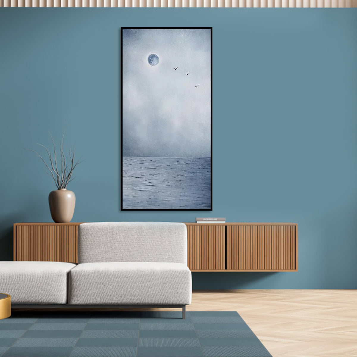 Moon art with a glowing full moon, misty ocean, and birds flying in the sky.