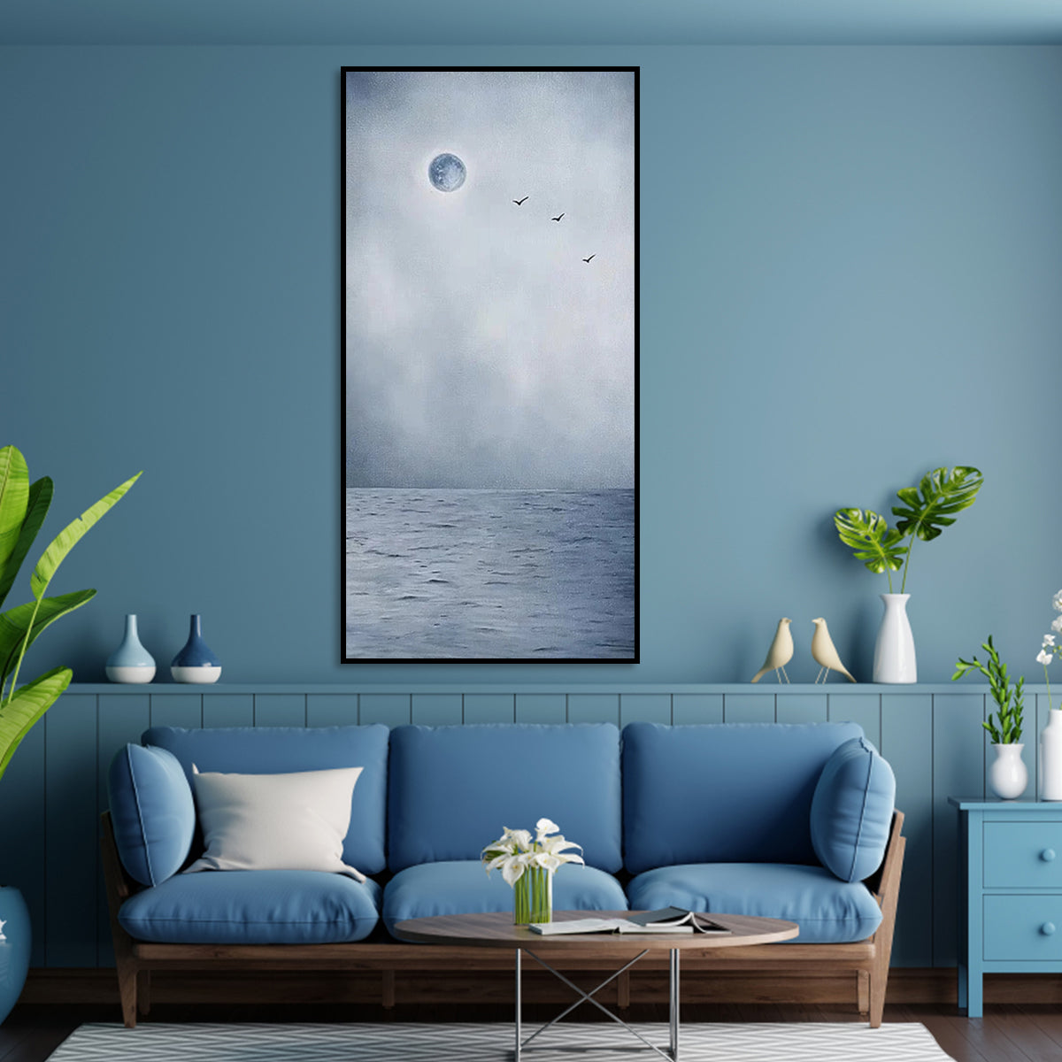 Moon art with a glowing full moon, misty ocean, and birds flying in the sky.