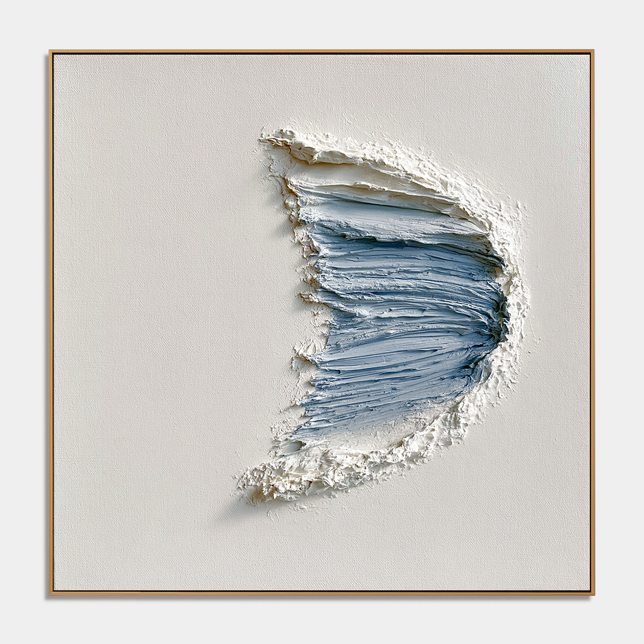 Blue textured abstract wall art with raised crescent brushstrokes in pale blue and white on a neutral background