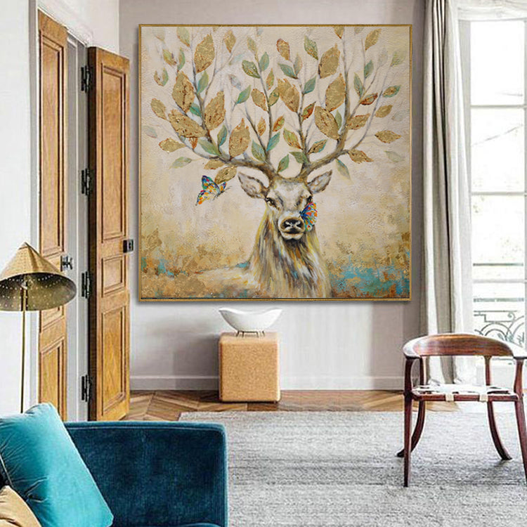 Deer wall art with antlers as tree branches and golden leaves, butterflies flying