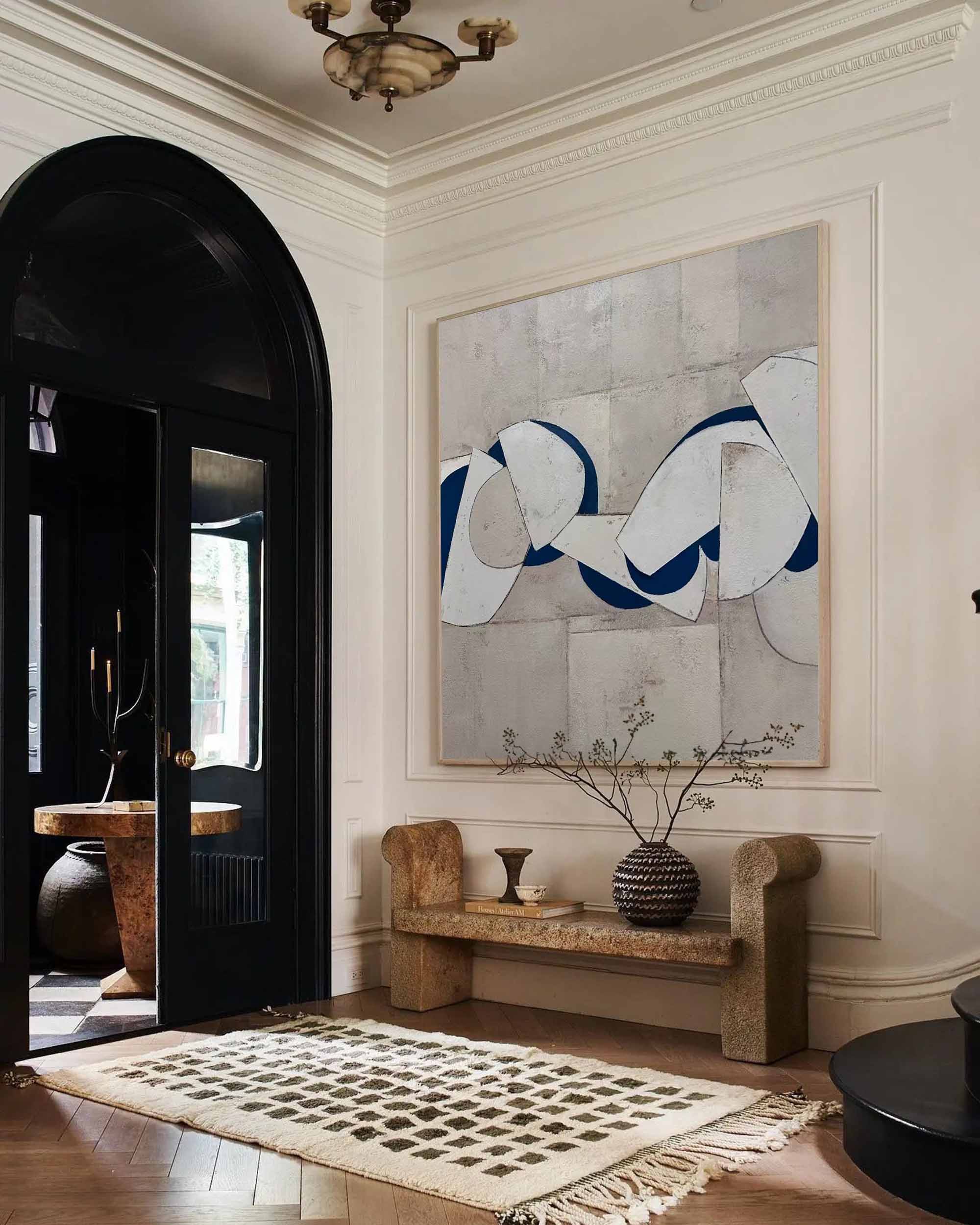 Blue and white abstract painting with bold curved shapes on textured gray background