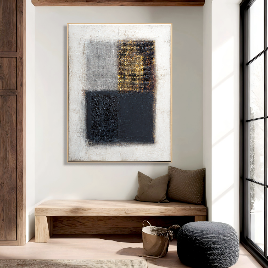 Abstract geometric art with black, gray, and gold textured squares on a white background.