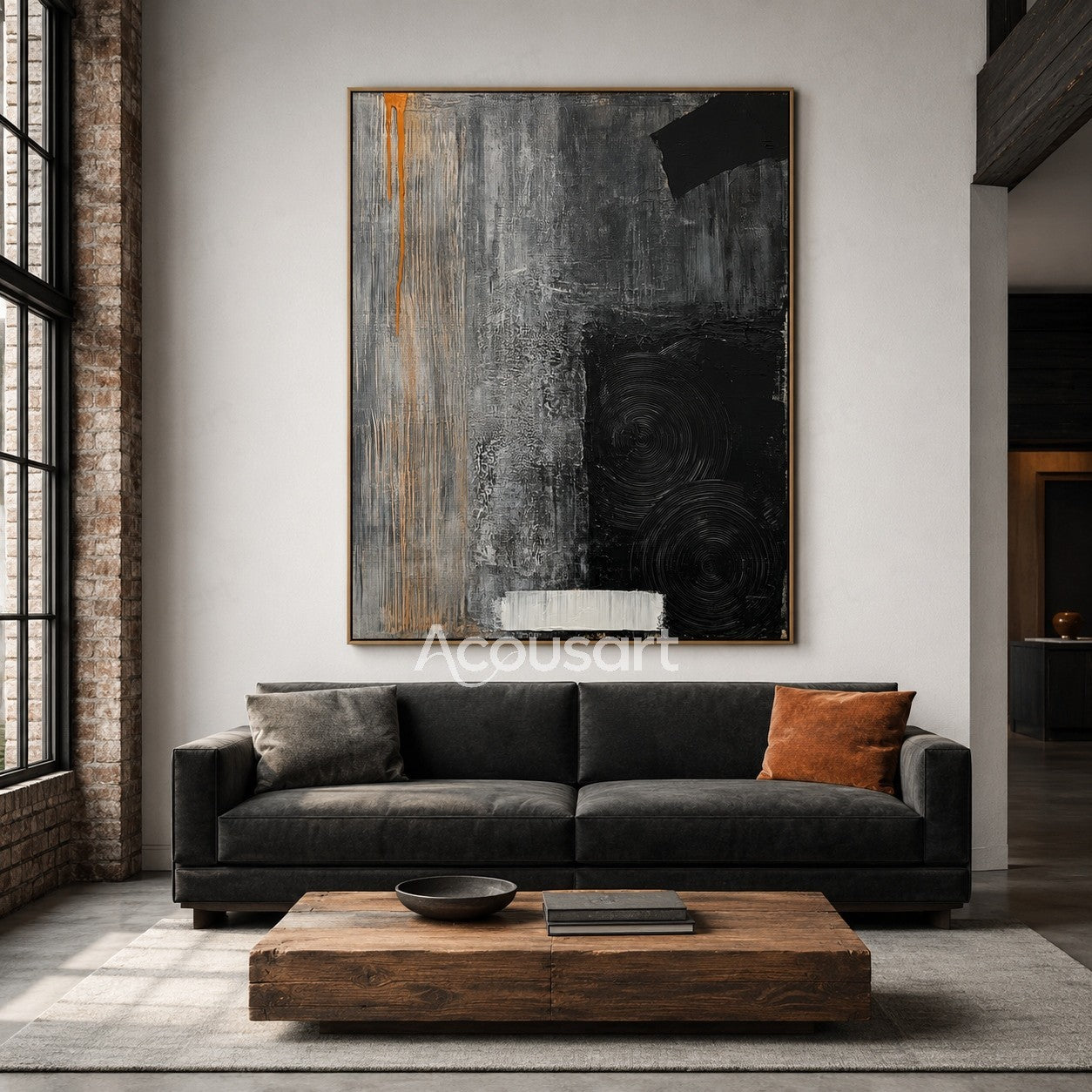 Textured abstract wall art in black, gray, white, and orange with circular patterns