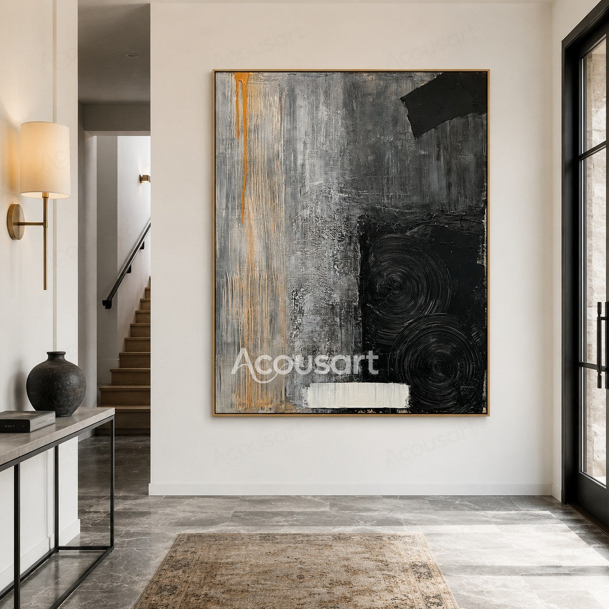 Textured abstract wall art in black, gray, white, and orange with circular patterns