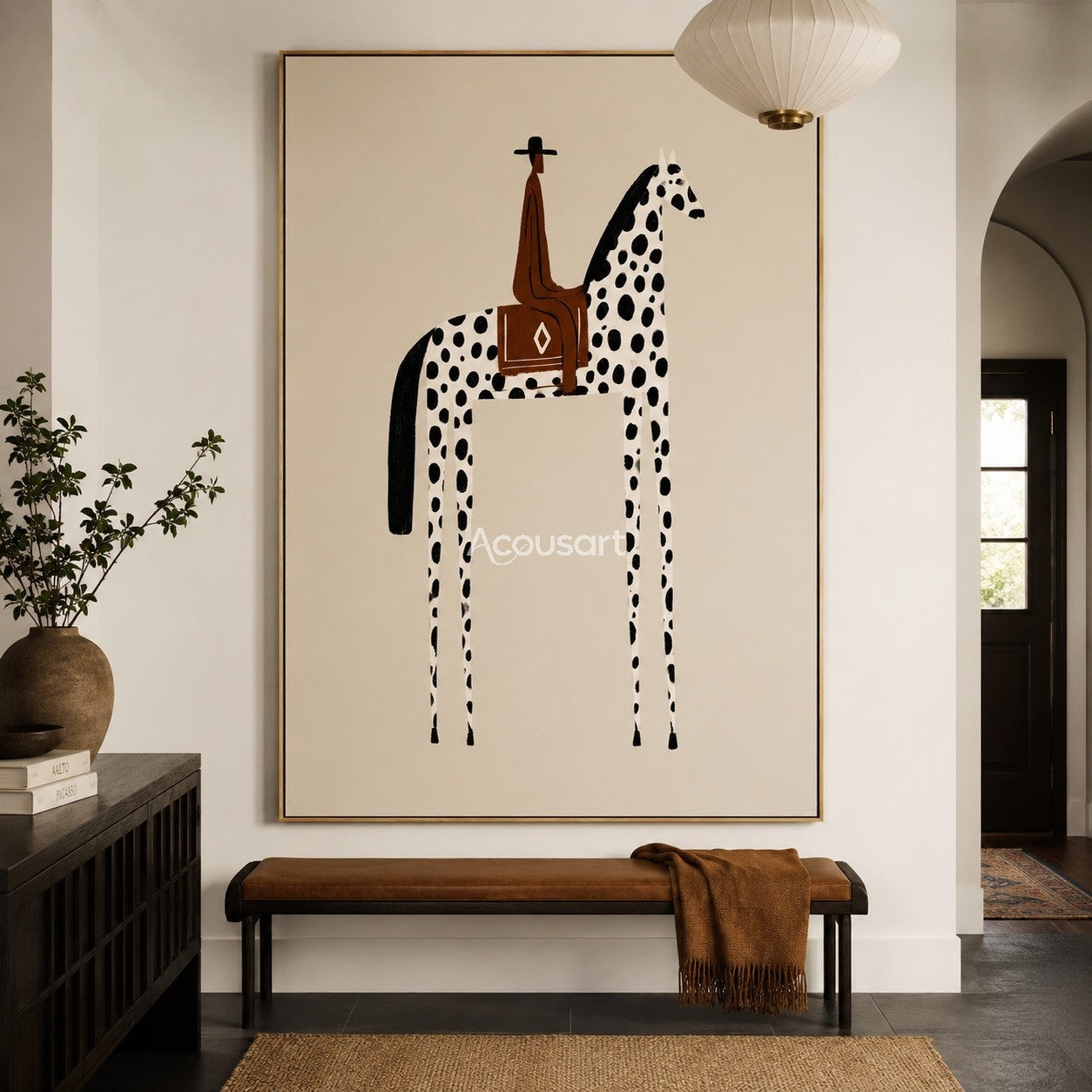 Western horse wall art with a rider on a black spotted white horse against a soft beige background